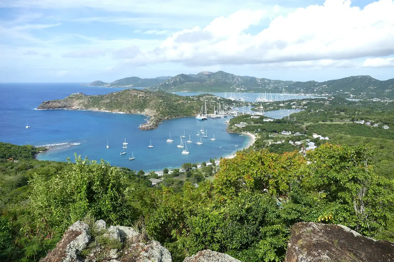 Green hills and deep blue bays of southern Antigua seen from the heights above English Harbour